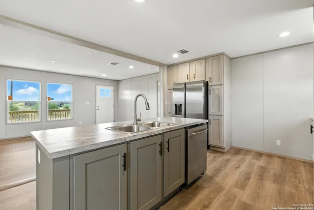 a kitchen with a table chairs refrigerator and microwave