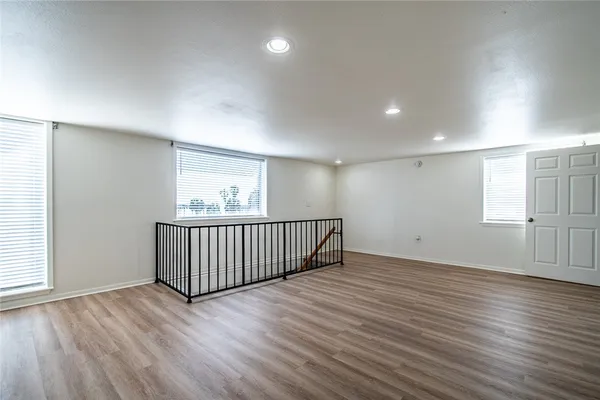 a view of a room with wooden floor and window