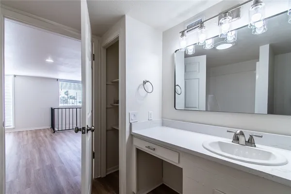 a en suite bathroom with a double vanity sink a mirror and shower