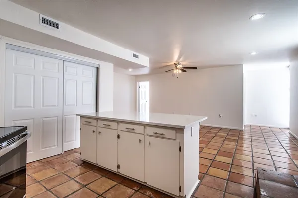 a view of a kitchen with white cabinets