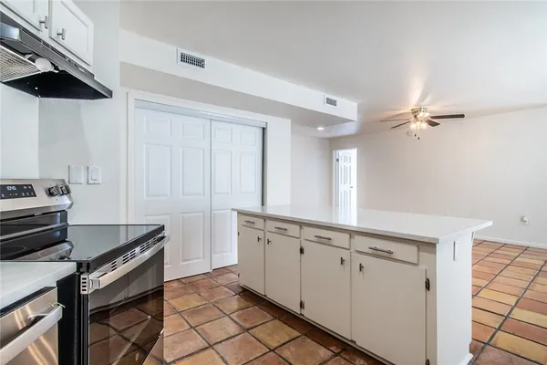 a kitchen with a sink appliances and cabinets