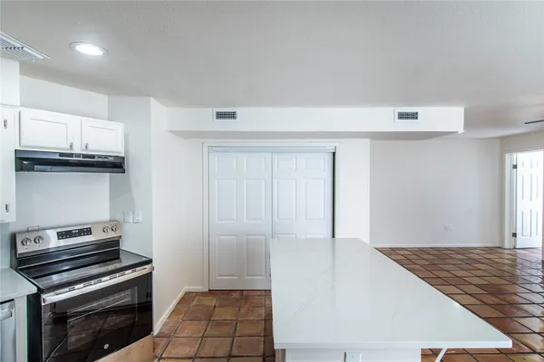 a view of kitchen with wooden floor and electronic appliances