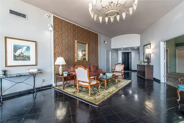 a living room with furniture and a chandelier
