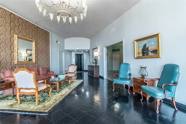 a living room with furniture and a chandelier