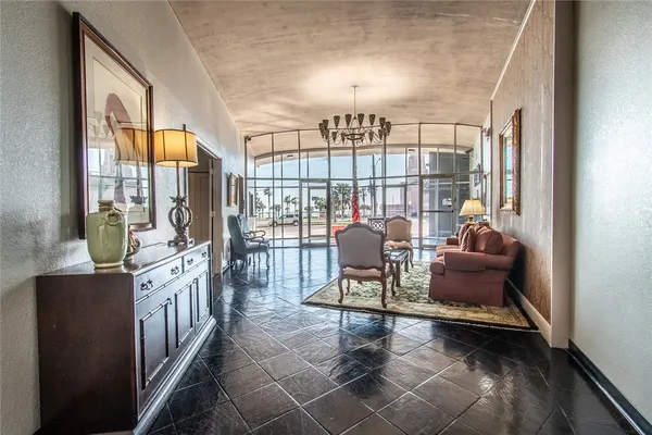 a living room with furniture and a floor to ceiling window