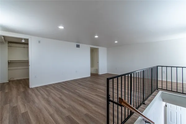 a view of hallway with wooden floor