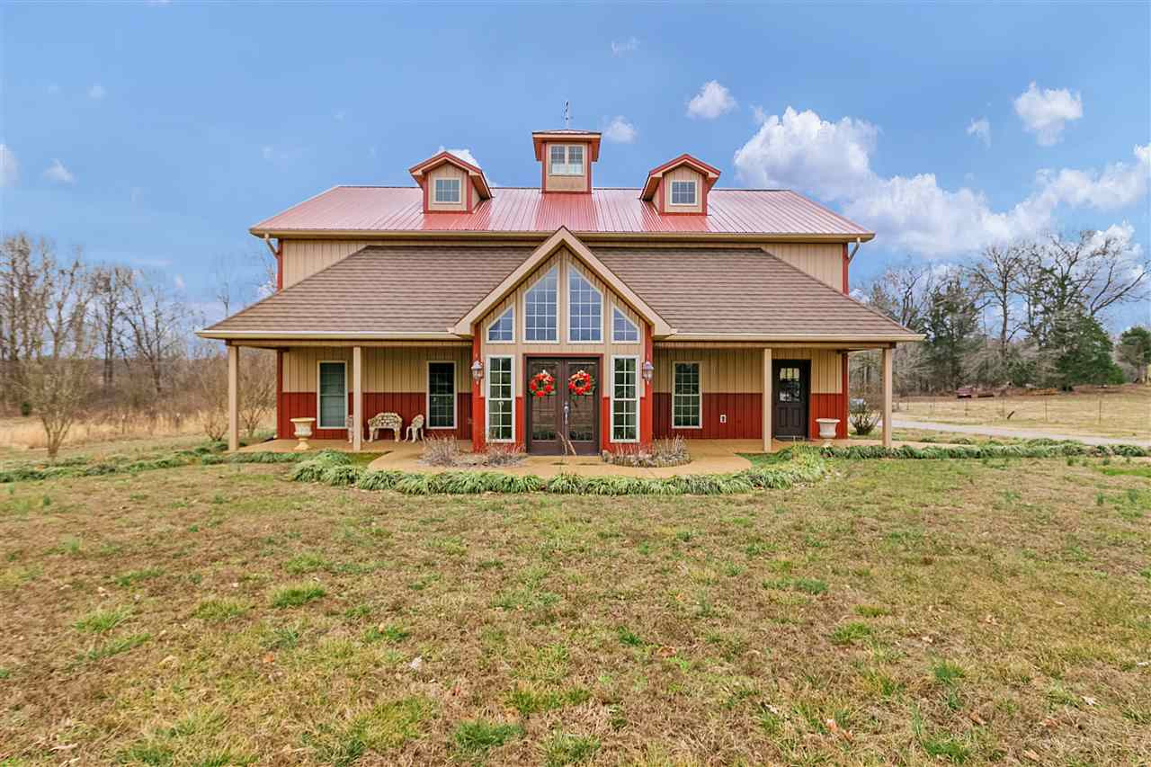 2245 Holder Road Cedar Grove, TN 38321 - Photo 1 of 1 a front view of a house with a garden