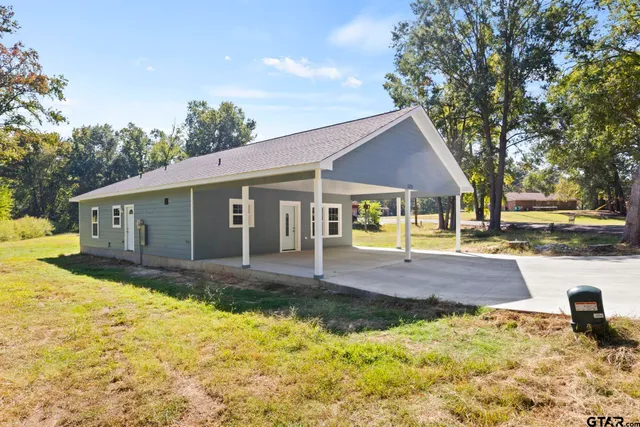 a view of a house with a yard covered with snow in the background
