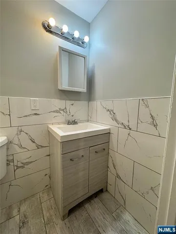 a bathroom with a sink vanity and a mirror