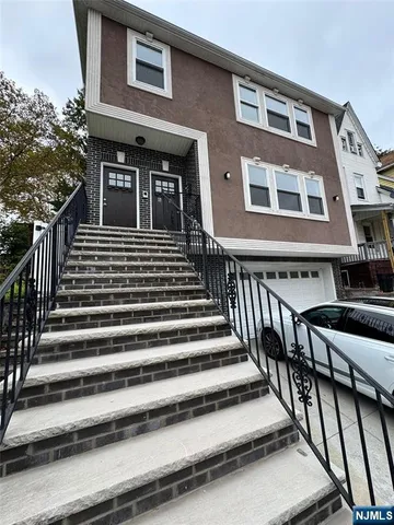 a view of a house with staircase and wooden stairs