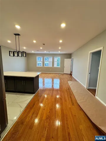a view of a kitchen with an entryway and a living room