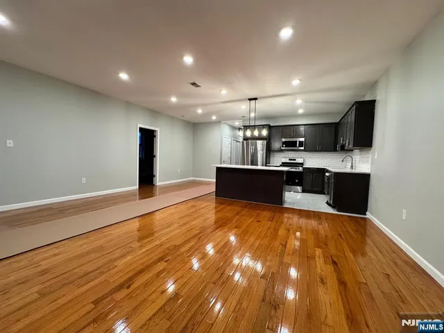 a view of kitchen and kitchen with granite countertop sink