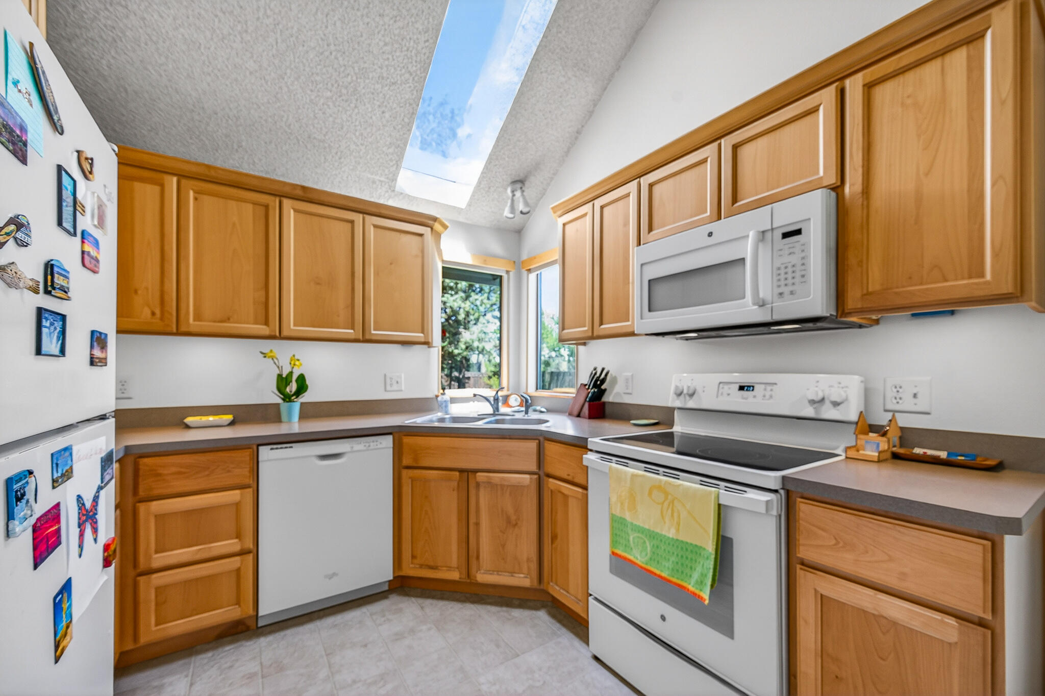 60866 Brosterhous Road Bend, OR 97702 - Photo 13 of 41 a kitchen with stainless steel appliances granite countertop a sink a stove and cabinets
