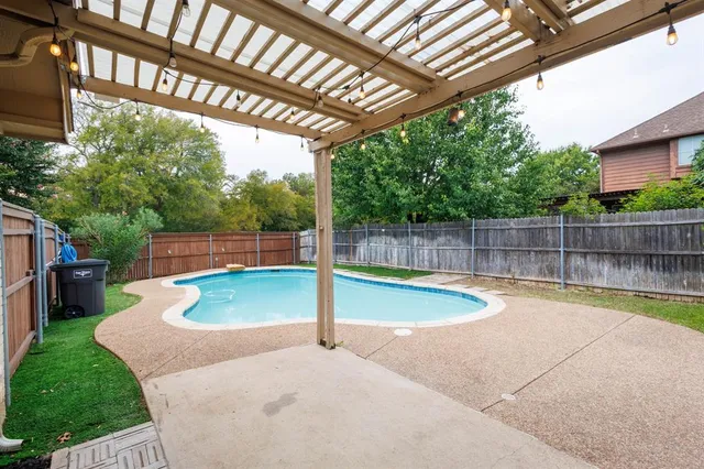 a view of a backyard with swimming pool