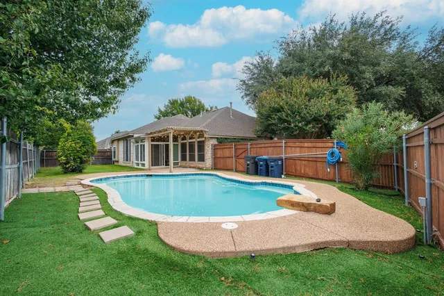 an aerial view of a house with swimming pool garden and patio