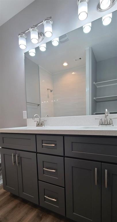 9114 Caddo Road, Unit A & B Houston, TX 77078 - Photo 14 of 24 Bathroom 3 - Double vanity featuring dark cabinetry with brushed nickel hardware and a light-toned countertop