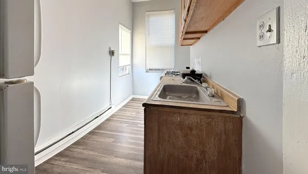 a view of a storage and utility room with a sink