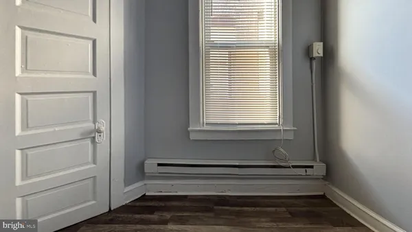 a bathroom with a window and a shower
