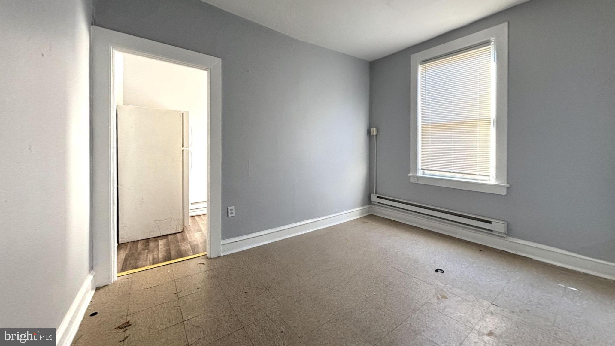 1908 South 65th Street Philadelphia, PA 19142 - Photo 5 of 6 an empty room with windows