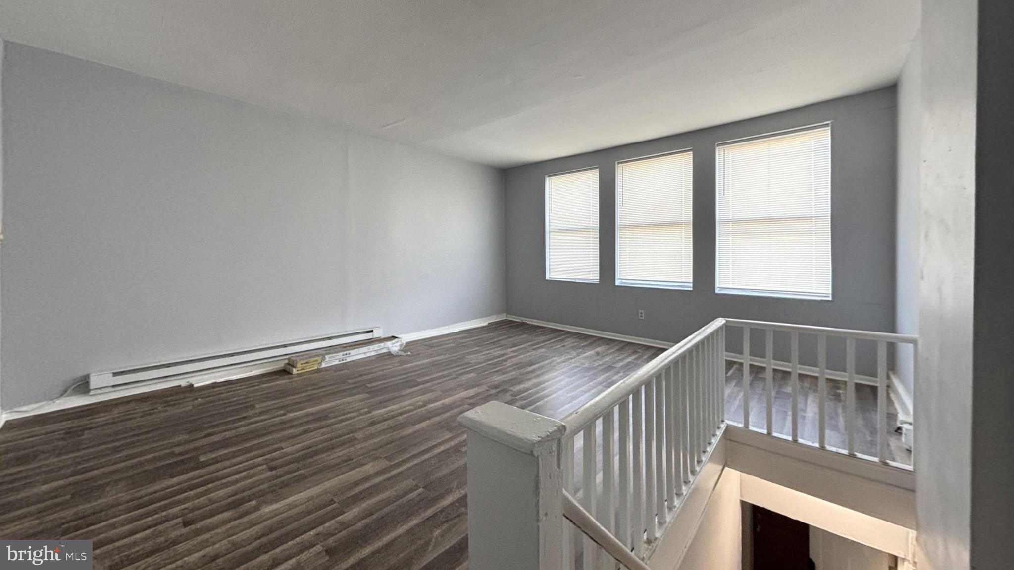 1908 South 65th Street Philadelphia, PA 19142 - Photo 6 of 6 a view of an empty room with wooden floor and a window