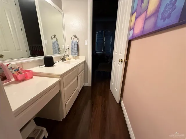 a bathroom with a sink a vanity and a mirror