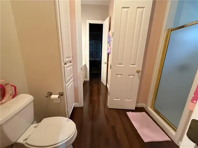 a bathroom with a toilet and a shower