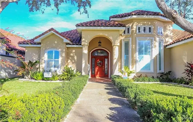 a front view of a house with a garden