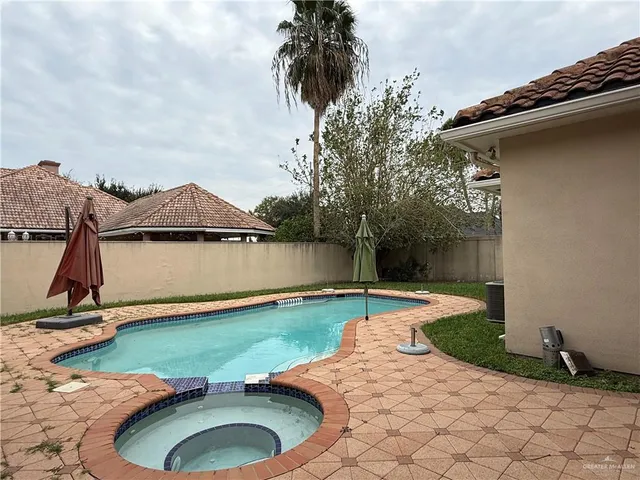 a swimming pool with some trees in the background