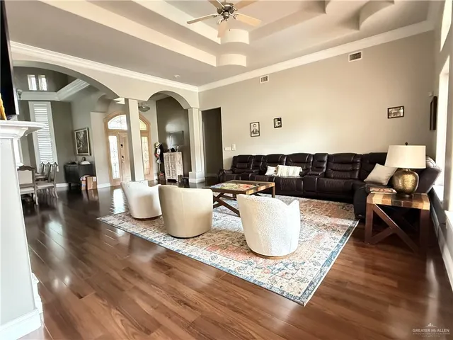 a living room with dining room and wooden floor