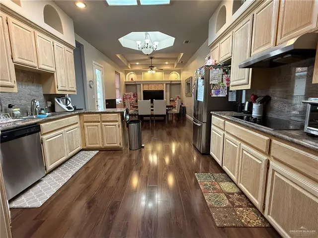 a kitchen with lots of counter top space and appliances