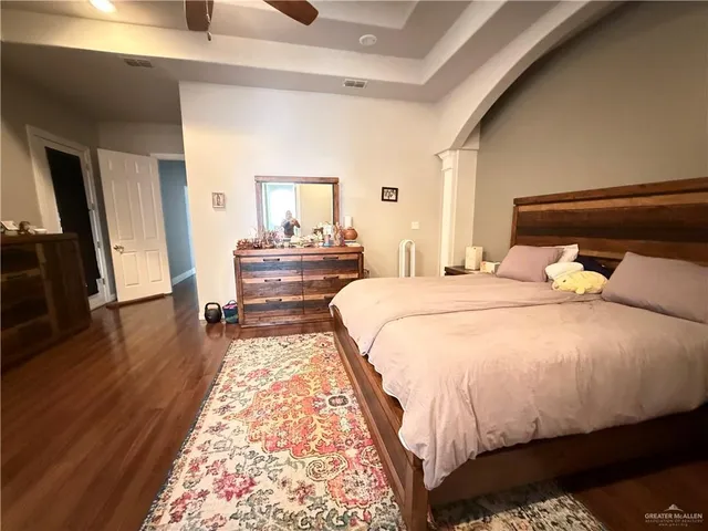 a bed room with a bed and a large window
