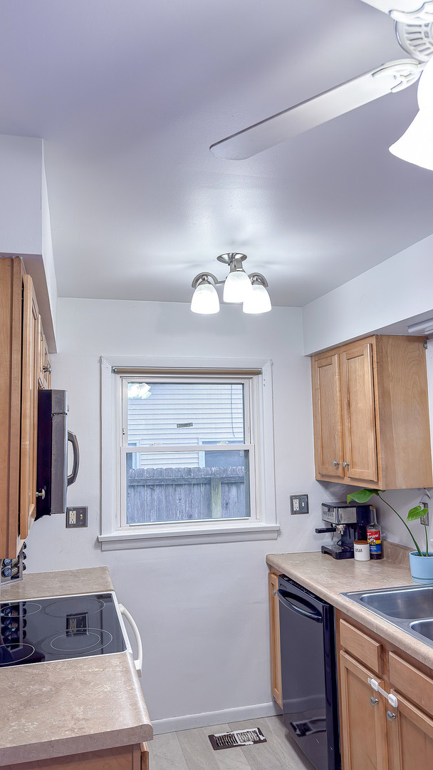 1709 West William Street Champaign, IL 61821 - Photo 11 of 20 a kitchen with a sink appliances and cabinets