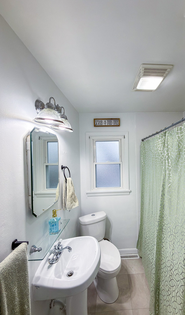 1709 West William Street Champaign, IL 61821 - Photo 16 of 20 a bathroom with a sink toilet and mirror