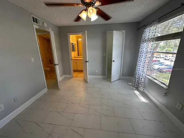 a view of a hallway with a ceiling fan