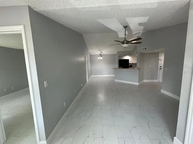 a view of a livingroom with a ceiling fan and window