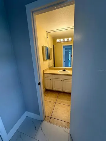 a bathroom with a granite countertop sink a toilet and shower