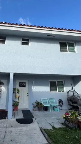 a view of a patio with table and chairs