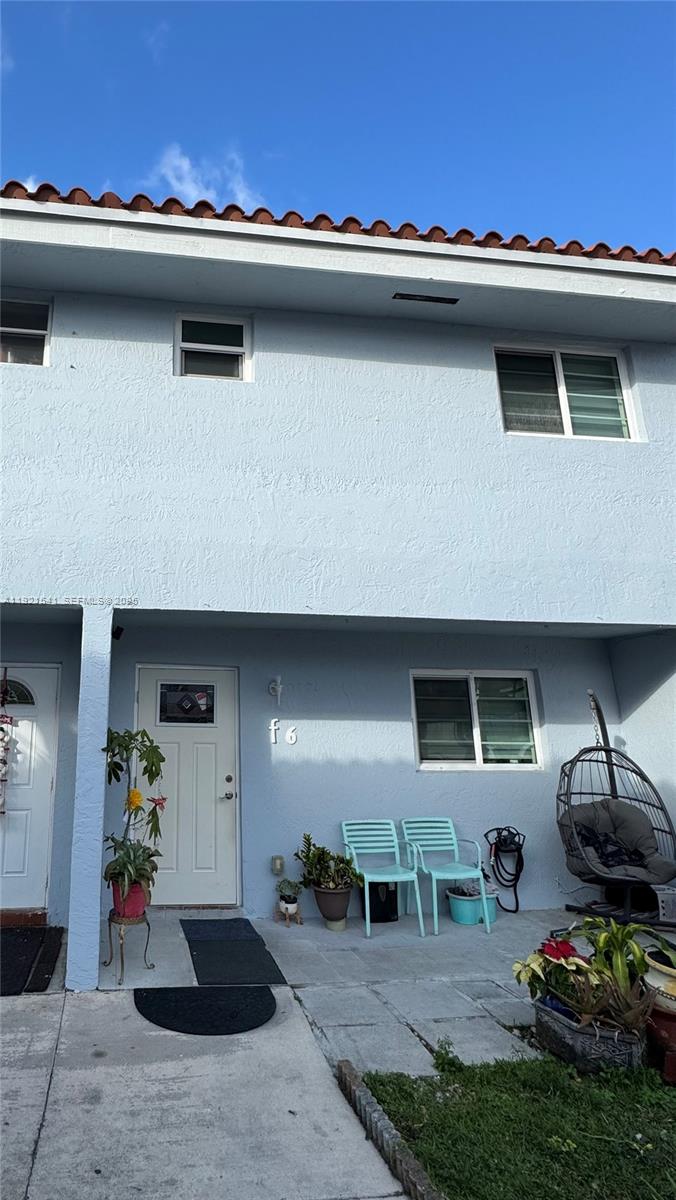 a view of a patio with table and chairs