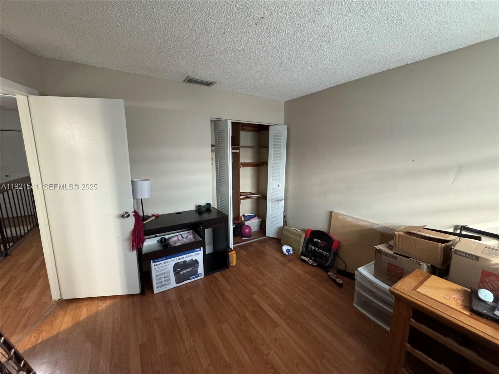 550 Southwest 115th Avenue, Unit 306F Sweetwater, FL 33174 - Photo 14 of 16 a living room with furniture and a wooden floor