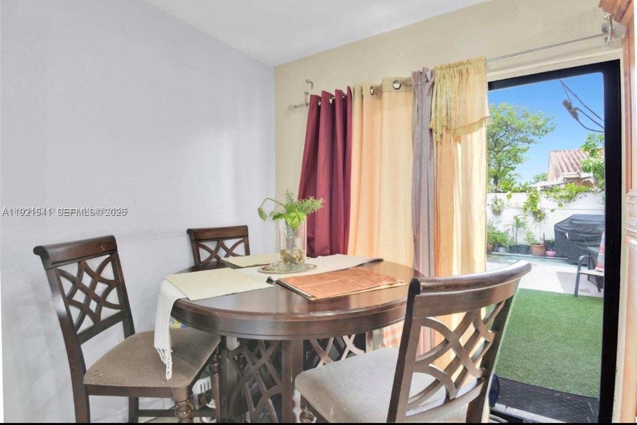 550 Southwest 115th Avenue, Unit 306F Sweetwater, FL 33174 - Photo 4 of 16 a view of a dining room with furniture and window