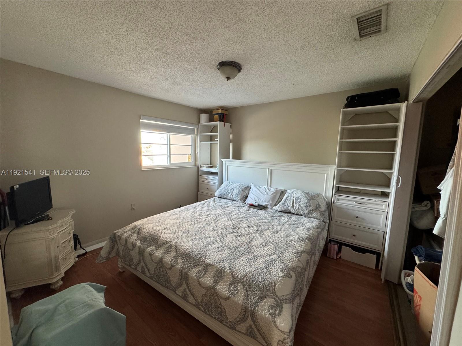 550 Southwest 115th Avenue, Unit 306F Sweetwater, FL 33174 - Photo 10 of 16 a bedroom with a bed and a television
