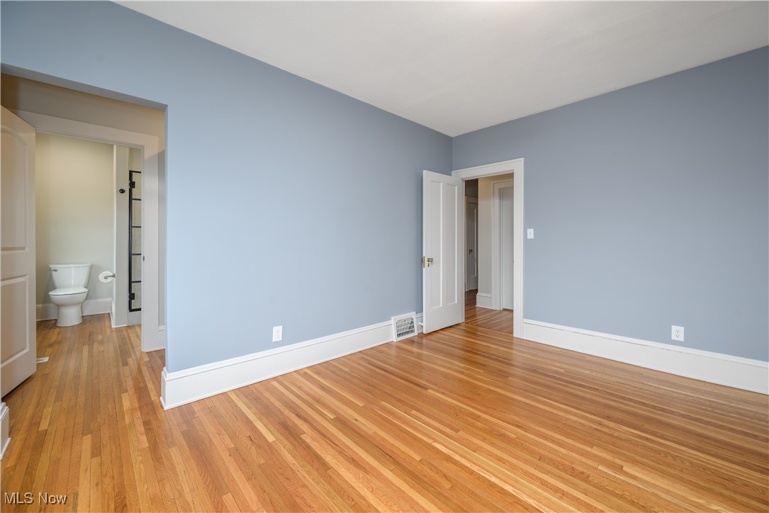 17728 Windward Road Cleveland, OH 44119 - Photo 23 of 32 Unfurnished bedroom with light hardwood / wood-style floors and ensuite bathroom