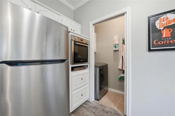 a hallway with cabinets and wooden floor