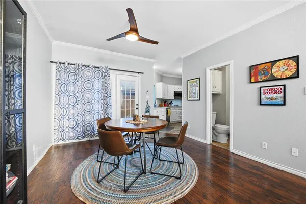 a dining room with furniture and wooden floor