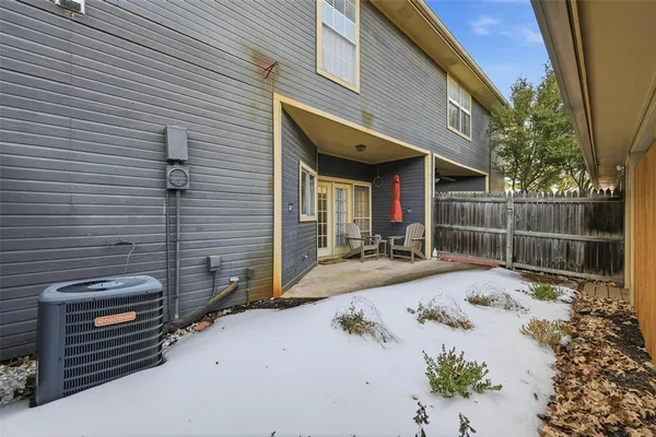 a view of a patio with table and chairs and potted plants