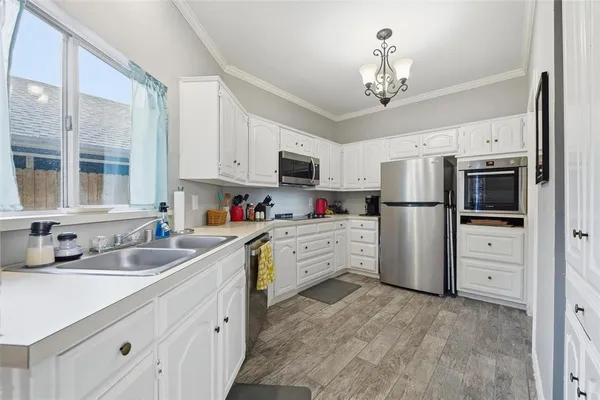 a kitchen with refrigerator and cabinets