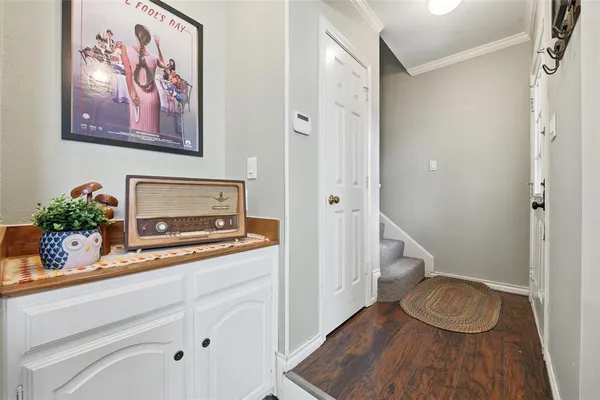 a bathroom with a toilet a sink and wooden floor