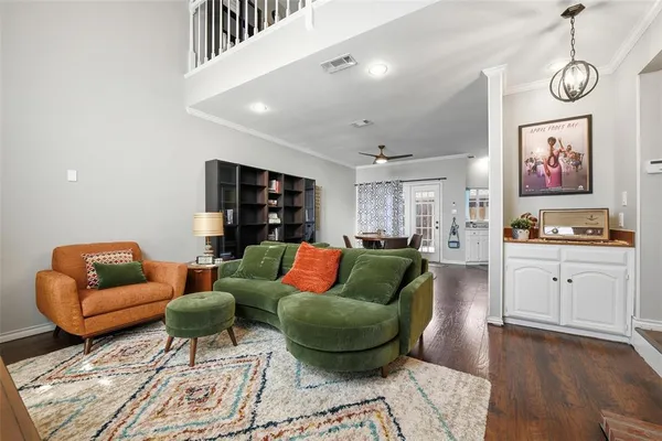 a living room with furniture and kitchen view