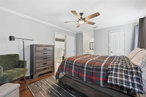 a bedroom with a bed and cabinet