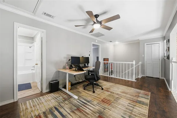 a workspace with wooden floor and a window